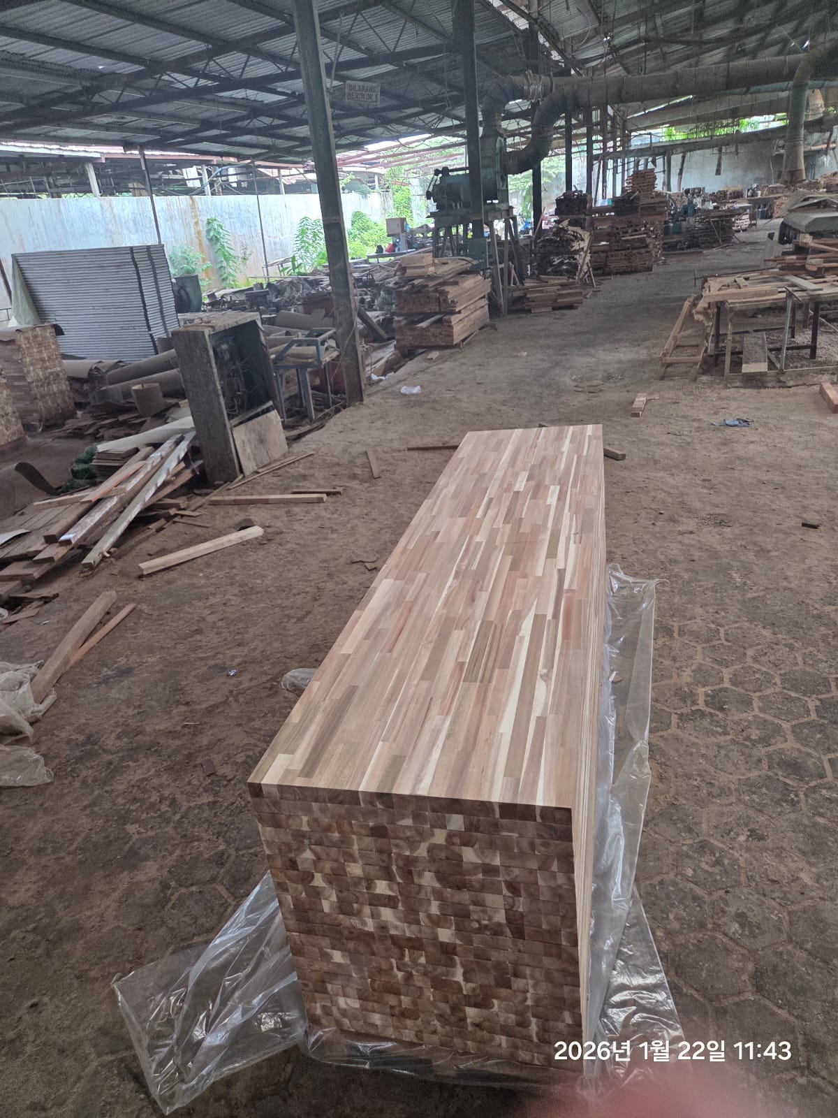 Indonesian wood production workshop with panel materials and equipment