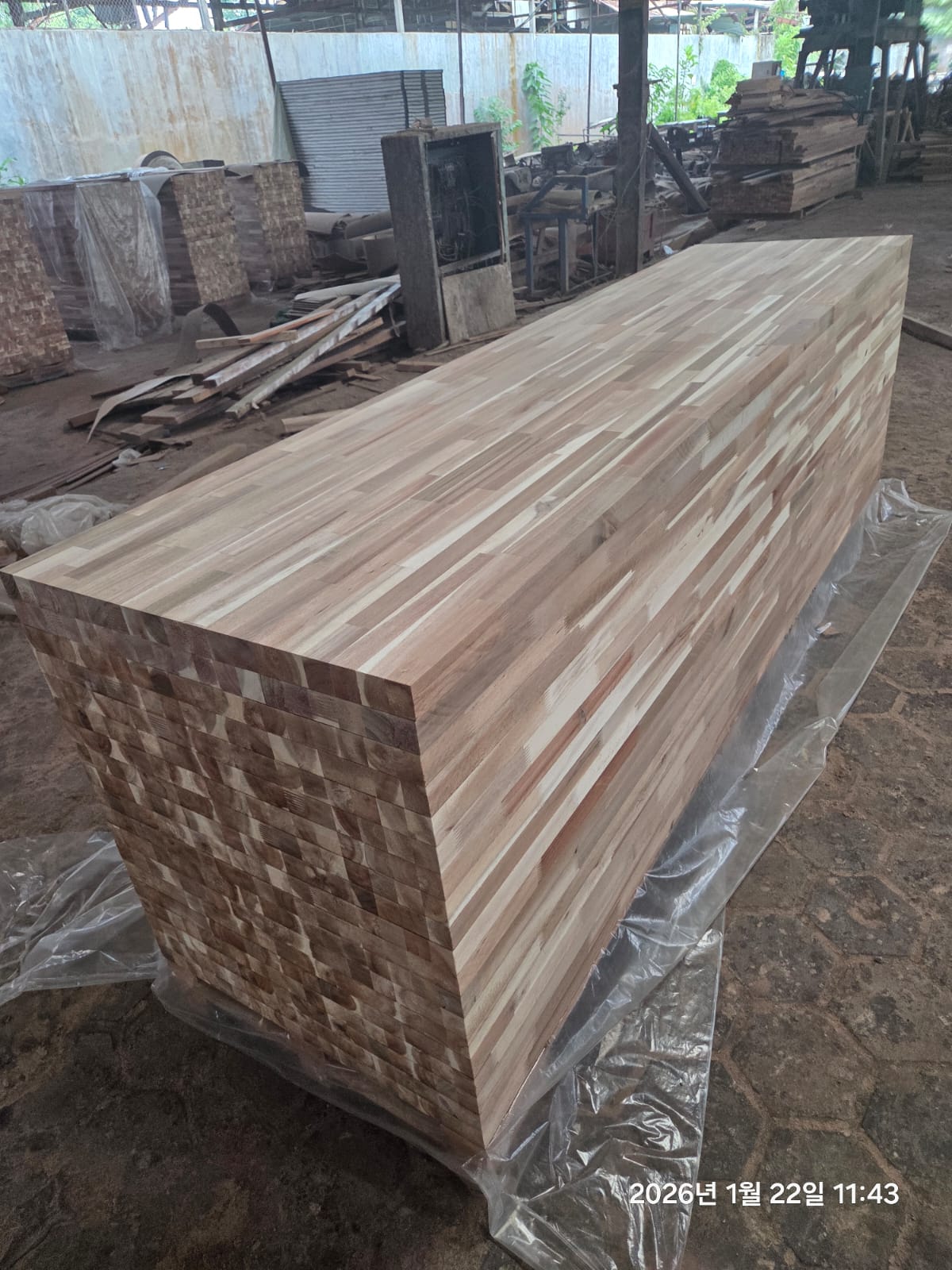 Stacks of butcher block panels in an Indonesian production workshop